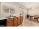 Kitchen area with sink, wood cabinets, and a view into the dining area at 2018 N 104Th Dr, Avondale, AZ 85392