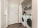 Laundry room with washer, dryer, wire shelving, and a door to the exterior at 2018 N 104Th Dr, Avondale, AZ 85392