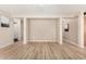 Spacious living room with wood-look floors, neutral wall color, and ample space for entertaining at 2018 N 104Th Dr, Avondale, AZ 85392