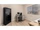 Office area with a desk, chair, computer, safe, and natural light from the window at 2018 N 104Th Dr, Avondale, AZ 85392