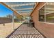 Covered patio area with grill, picnic table, and view of backyard at 2018 N 104Th Dr, Avondale, AZ 85392