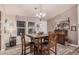 Comfortable dining space with matching wood table and chairs set beneath a classic chandelier and adjacent to sunlit windows at 2263 N Trekell Rd # 159, Casa Grande, AZ 85122
