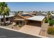 Exterior of a home with solar panels, carport, and low-maintenance landscaping at 2263 N Trekell Rd # 159, Casa Grande, AZ 85122