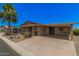Cozy home showcasing a covered parking area, complemented by rock landscaping and a vibrant palm tree at 2263 N Trekell Rd # 159, Casa Grande, AZ 85122