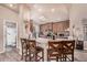 Bright kitchen with a breakfast bar, light countertops, skylight, and ample wooden cabinetry for storage at 2263 N Trekell Rd # 159, Casa Grande, AZ 85122