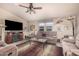Comfortable living room furnished with plush seating, a ceiling fan, and an entertainment center with a fireplace at 2263 N Trekell Rd # 159, Casa Grande, AZ 85122