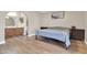 Bedroom featuring an en suite bath and modern wood-look vinyl plank flooring at 2324 E Crescent Ave, Mesa, AZ 85204