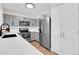 Modern kitchen featuring stainless steel appliances, gray cabinets, and quartz countertops at 2324 E Crescent Ave, Mesa, AZ 85204