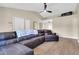Bright living room with vaulted ceilings, ceiling fan, and a large sectional sofa at 2324 E Crescent Ave, Mesa, AZ 85204