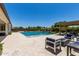 Stunning backyard with lush landscaping, sparkling pool, and outdoor seating areas at 24840 S 195Th St, Queen Creek, AZ 85142