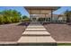 Elegant stone stairway leads to a covered patio featuring a ceiling fan and outdoor dining area at 24840 S 195Th St, Queen Creek, AZ 85142