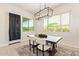 Cozy dining room featuring a modern chandelier, a wooden table with four chairs, and natural light at 24840 S 195Th St, Queen Creek, AZ 85142