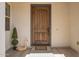 Charming front door with wood finish, enhanced by elegant decorative plants and modern exterior at 24840 S 195Th St, Queen Creek, AZ 85142