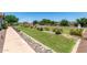 Well-manicured front yard with a beautiful rock garden, lush grass, and tasteful landscaping at 24840 S 195Th St, Queen Creek, AZ 85142
