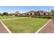 Beautifully landscaped front yard featuring a lush lawn, mature trees, and a walkway leading to the home at 24840 S 195Th St, Queen Creek, AZ 85142