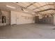 Spacious garage with overhead lighting, gray storage cabinets, and an epoxy floor at 24840 S 195Th St, Queen Creek, AZ 85142