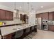 Elegant kitchen featuring a large island with seating, stainless steel appliances, and ample cabinet space at 24840 S 195Th St, Queen Creek, AZ 85142