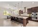 Modern kitchen showcasing a large island with seating, stainless steel appliances, and stylish pendant lighting at 24840 S 195Th St, Queen Creek, AZ 85142