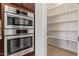Close-up of a kitchen with a built-in oven and microwave with a pantry around the corner at 24840 S 195Th St, Queen Creek, AZ 85142