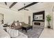 Inviting living room featuring a cozy fireplace, complemented by stylish decor and plenty of natural light at 24840 S 195Th St, Queen Creek, AZ 85142
