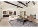 Spacious living room with high ceilings, wood beams, and an open layout flowing into the modern kitchen at 24840 S 195Th St, Queen Creek, AZ 85142