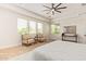 Spacious main bedroom with two armchairs in front of windows and a ceiling fan at 24840 S 195Th St, Queen Creek, AZ 85142