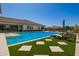 Stunning backyard pool area with ample patio space and modern lounge furniture at 24840 S 195Th St, Queen Creek, AZ 85142