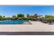 Lovely backyard featuring a pool, lush greenery, and a covered seating area at 24840 S 195Th St, Queen Creek, AZ 85142