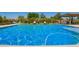 Backyard swimming pool with blue water and surrounding greenery, perfect for relaxation at 24840 S 195Th St, Queen Creek, AZ 85142