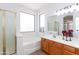 Bright bathroom featuring a soaker tub, separate shower, and a double sink vanity at 2527 E Remington Pl, Chandler, AZ 85286