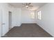 Spacious bedroom with neutral carpet, a ceiling fan, and natural light from two windows at 2527 E Remington Pl, Chandler, AZ 85286