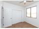 Bedroom featuring a ceiling fan, closet with sliding doors, and neutral paint at 2527 E Remington Pl, Chandler, AZ 85286