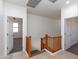 Upstairs hallway with wood railing and two doorways leading to separate rooms at 2527 E Remington Pl, Chandler, AZ 85286