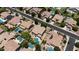 Expansive aerial view of a neighborhood featuring houses with pools and well-maintained landscaping at 2541 E Carob Dr, Gilbert, AZ 85298