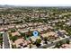 An aerial view of the residence nestled in a neighborhood featuring a private pool and lush landscaping at 2541 E Carob Dr, Gilbert, AZ 85298