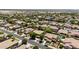 An expansive aerial shot showcases a neighborhood with mature trees and well-maintained homes, some featuring private pools at 2541 E Carob Dr, Gilbert, AZ 85298