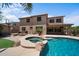 Backyard showcasing a pool with spa, built-in fire pit, and basketball court at 2541 E Carob Dr, Gilbert, AZ 85298