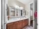 Bathroom featuring double sinks with vanity and an open doorway at 2541 E Carob Dr, Gilbert, AZ 85298