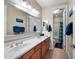 Bathroom with double sinks, large mirror and door to private toilet and shower area at 2541 E Carob Dr, Gilbert, AZ 85298