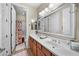 Bathroom featuring a double sink vanity with a shower and a bathtub with floral curtains at 2541 E Carob Dr, Gilbert, AZ 85298