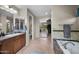 Bathroom featuring double sinks, bathtub and access to toilet and walk-in closet at 2541 E Carob Dr, Gilbert, AZ 85298