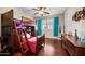 Bedroom with hardwood floors, ladder bunk bed, ceiling fan, dresser and a window at 2541 E Carob Dr, Gilbert, AZ 85298