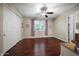 Inviting bedroom with wood floors, ceiling fan, a large window, and a closet at 2541 E Carob Dr, Gilbert, AZ 85298