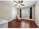 Bedroom with hardwood floors, ceiling fan and window view of backyard at 2541 E Carob Dr, Gilbert, AZ 85298