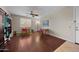 Spacious bedroom with hardwood floors, ceiling fan, and a large window providing natural light at 2541 E Carob Dr, Gilbert, AZ 85298