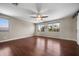 Large bedroom with hardwood floors, ample windows, and a ceiling fan at 2541 E Carob Dr, Gilbert, AZ 85298