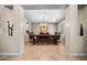 Formal dining room featuring a large wooden table, bench seating, and decorative chandelier at 2541 E Carob Dr, Gilbert, AZ 85298