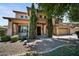 Inviting two-story home with meticulously landscaped front yard and charming architectural details in daylight at 2541 E Carob Dr, Gilbert, AZ 85298