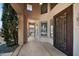 View of the front porch with decorative iron door and covered walkway leading to the entrance at 2541 E Carob Dr, Gilbert, AZ 85298