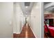 Long hallway with hardwood floors and multiple doors at 2541 E Carob Dr, Gilbert, AZ 85298